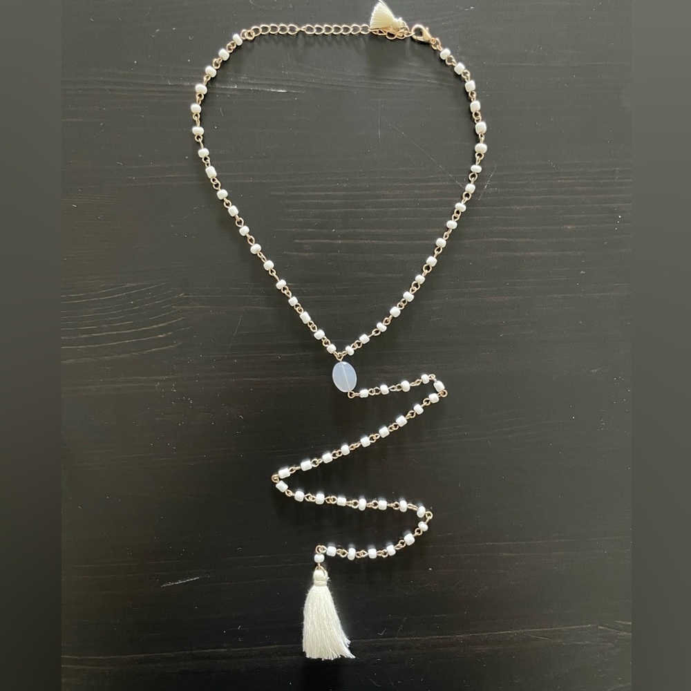 White and gold necklace with tassel
